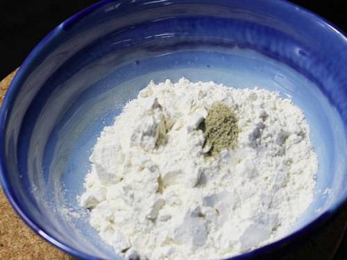 flour and cardamom powder in a bowl