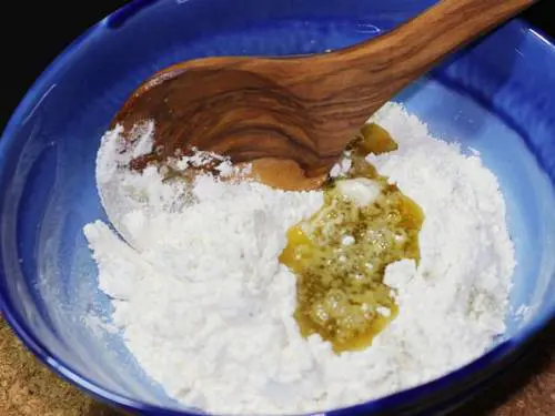 adding sugar syrup to make shankarpali dough