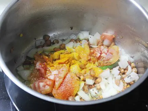 adding tomatoes and turmeric