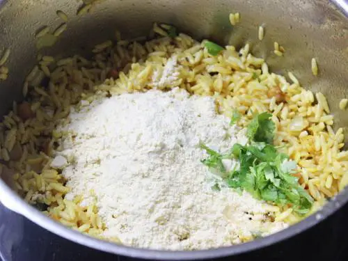 adding fried gram powder and coriander leaves