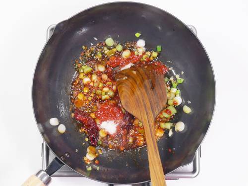 adding red chilli paste for szechuan chicken