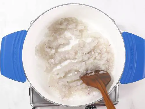 frying onions to make goan chicken vindaloo