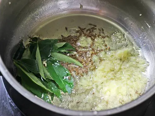 tempering spices in ghee to make green gram curry