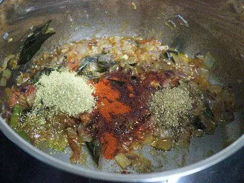 sauteing masala to make green gram curry