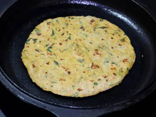 toasting mix veg paratha on a griddle