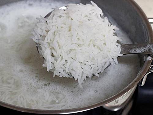 cooking rice to make paneer biryani