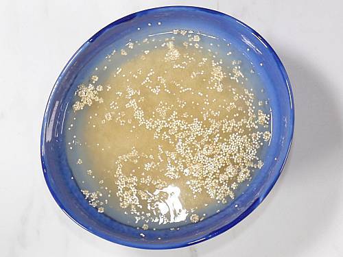 rinsing quinoa in a large bowl