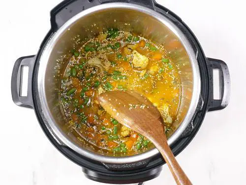 pouring water to make quinoa pulao