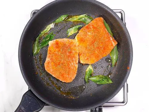 frying salmon in a pan