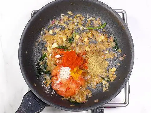 adding spice powders to the pan