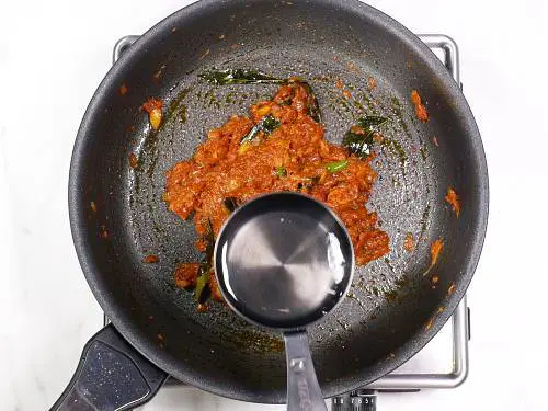 pouring water to make salmon curry