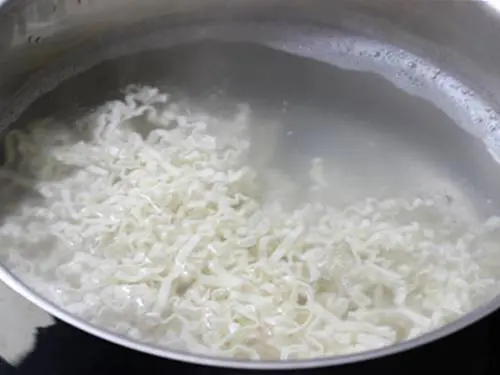 boiling noodles in a large pot