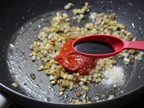 adding soya sauce, salt sugar to make schezwan noodles