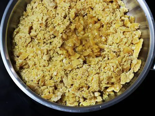 adding jaggery to make til ke laddu