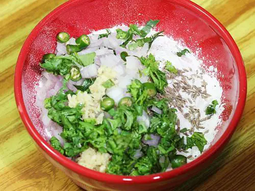 adding coriander ginger green chilies