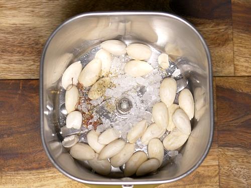 adding peeled almonds to a blender