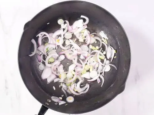 frying onions to make hakka noodles