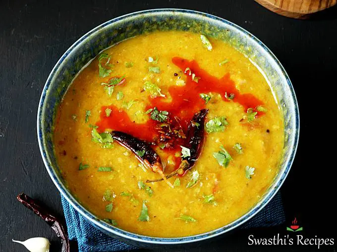 masoor dal garnished with red chilies served in a blue bowl