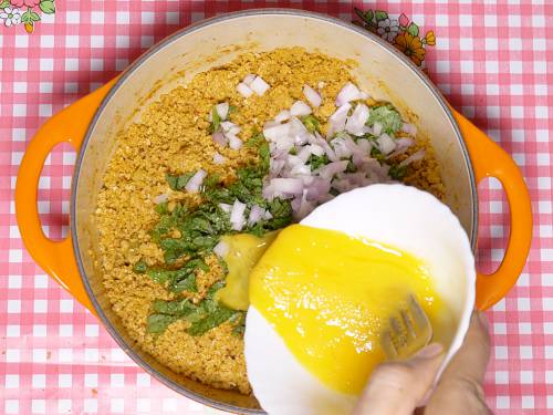 adding egg to processed ingredients to make shami kabab
