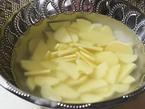 sliced sweet potatoes in water
