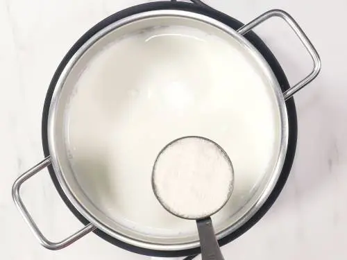 Adding sugar to boiling milk