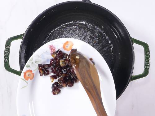 transferring fried dates to a plate