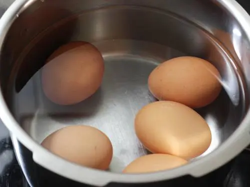 boiling eggs in a pot
