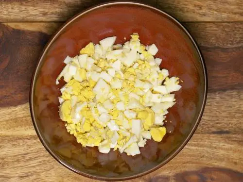 chopped eggs for salad in a mixing bowl