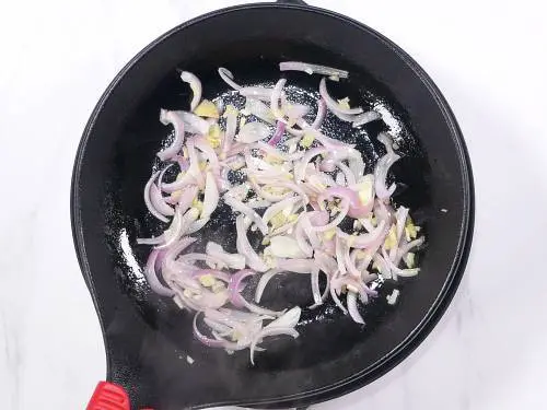 frying onions to make zucchini stir fry
