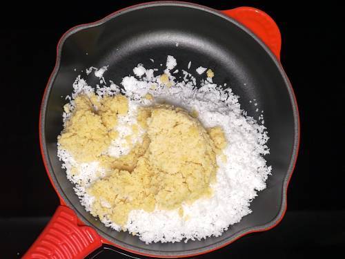 adding jaggery to a wide pan