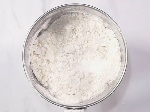 powdered sugar and rava in a grinder jar