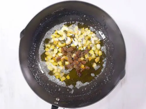 frying cashews in ghee to make rava laddu