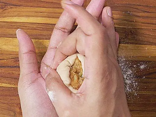 stretching dough to close the stuffing