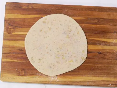 rolling stuffed aloo paratha