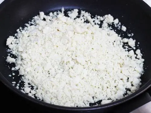 grated mawa in a pan