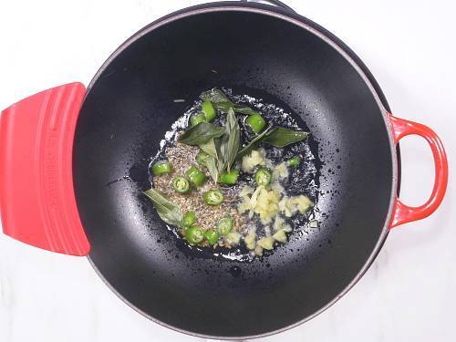 sauteing ginger chilies and curry leaves