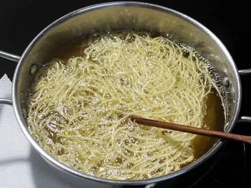 inverting aloo sev in oil