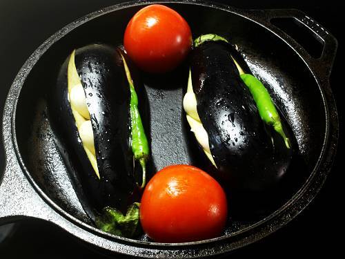 garlic chilli studded eggplants ready for broiling in oven