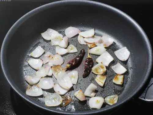 frying red chilies in oil to temper 