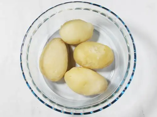 peeling boiled potatoes