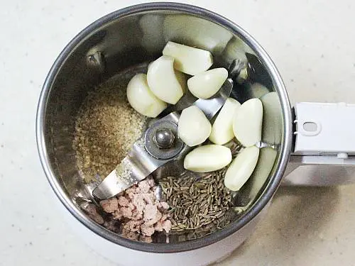 adding all the ingredients to grinder