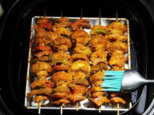 brushing air fryer mushroom tikka with butter