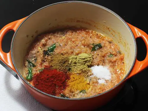 adding spice powders to make carrot curry