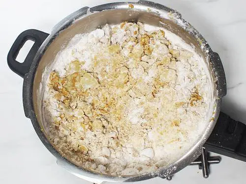 knead sugar and besan to make ladoo