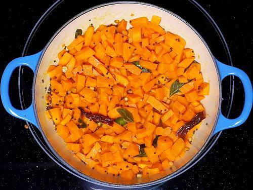 stir frying carrots to make poriyal