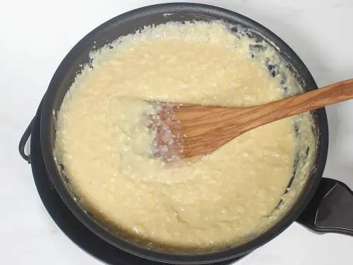 thick kalakand mixture cooking in a pan