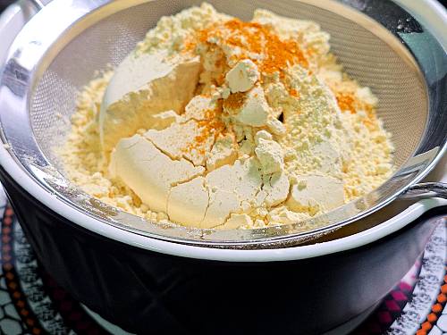 sieving flour and turmeric