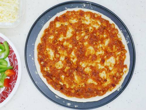 spread sauce over the pizza base