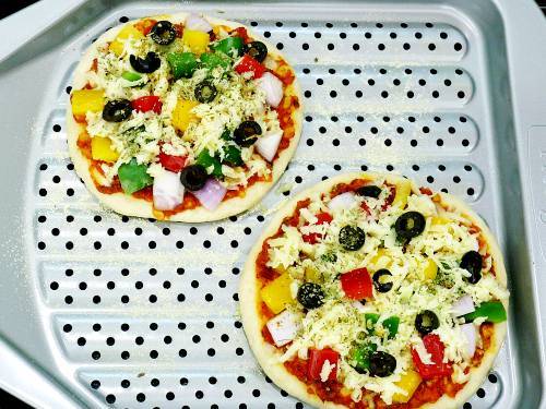 thick crust pizza on a perforated baking pan