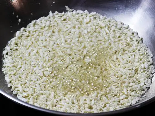 deep frying poha in oil to make chivda